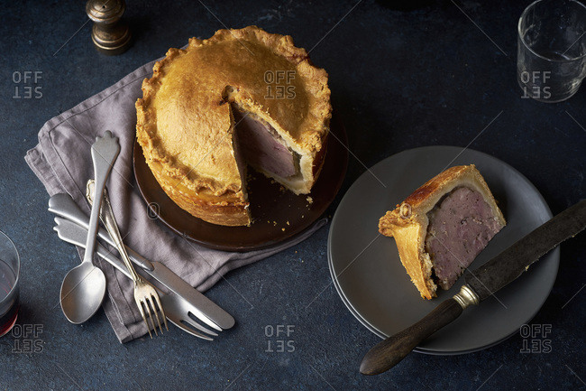Traditional British raised pork pie with bacon and herbs