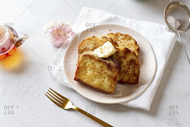 French toasts for breakfast with butter and powdered sugar view from above