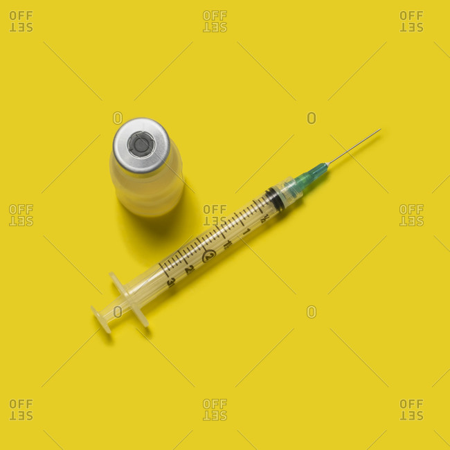 Studio shot of laboratory vial and syringe