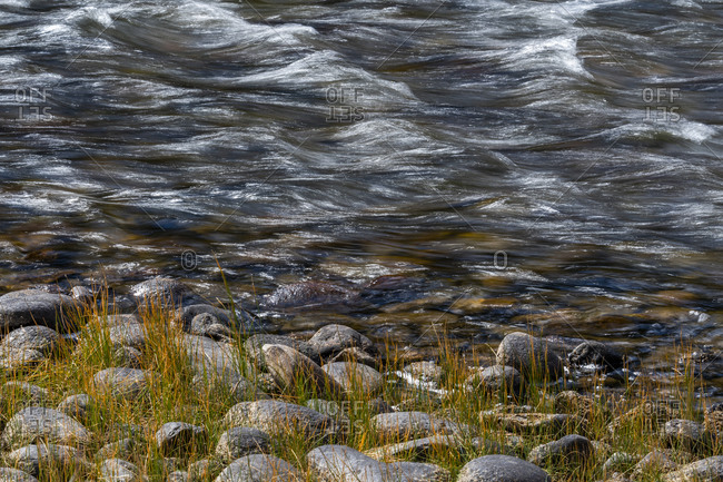 Motion blurred water and bank of Salmon River