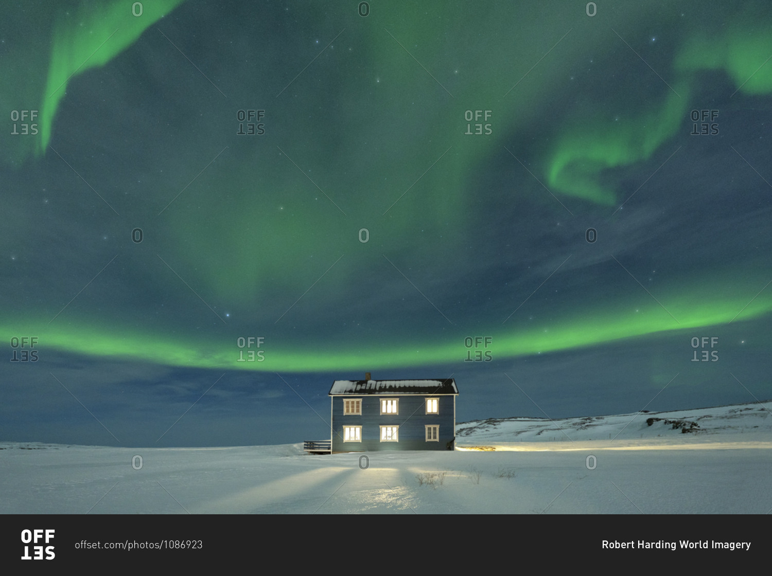 Northern Lights (Aurora borealis) on the illuminated house in the snow, Veines, Kongsfjord, Varanger Peninsula, Finnmark, Norway, Scandinavia, Europe