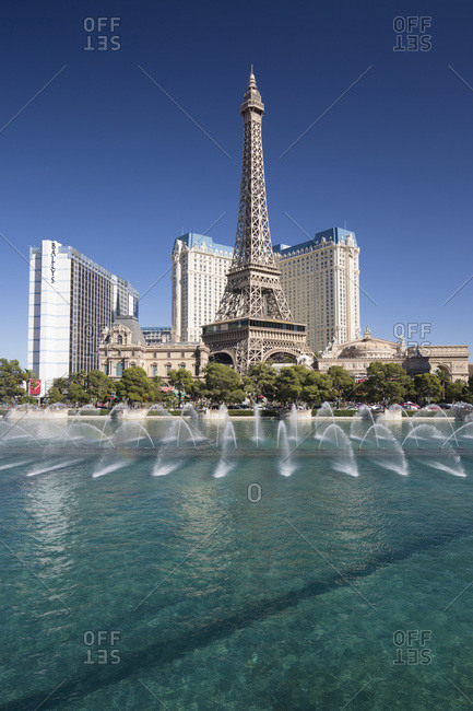 October 15, 2017: View across lake to replica Eiffel Tower at the Paris Hotel and Casino, Bellagio fountains in foreground, Las Vegas, Nevada, United States of America, North America