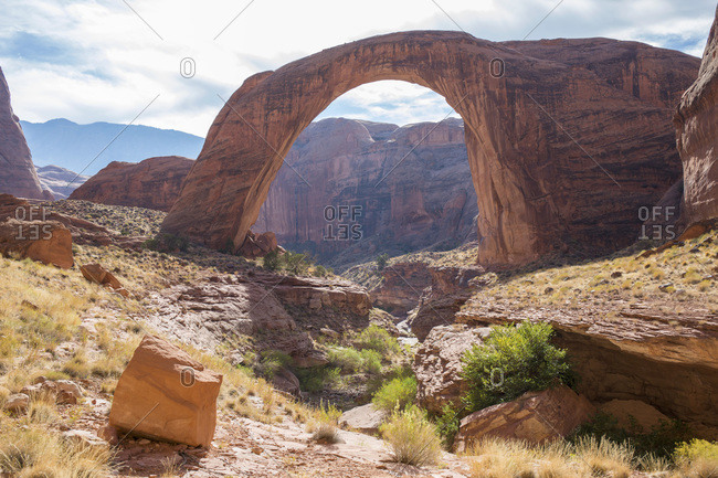 View across rocky landscape to Rainbow Bridge National Monument, Glen Canyon National Recreation Area, Utah, United States of America, North America