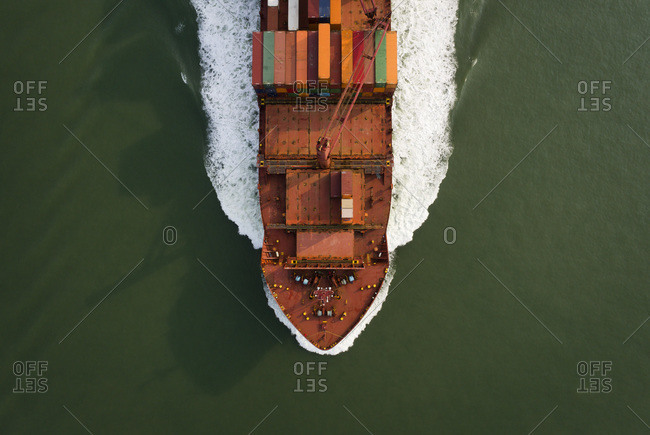 A large container ship sails to the port of Antwerp from the Netherlands