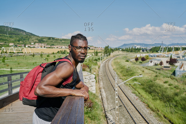 Young man on bridge by railway track