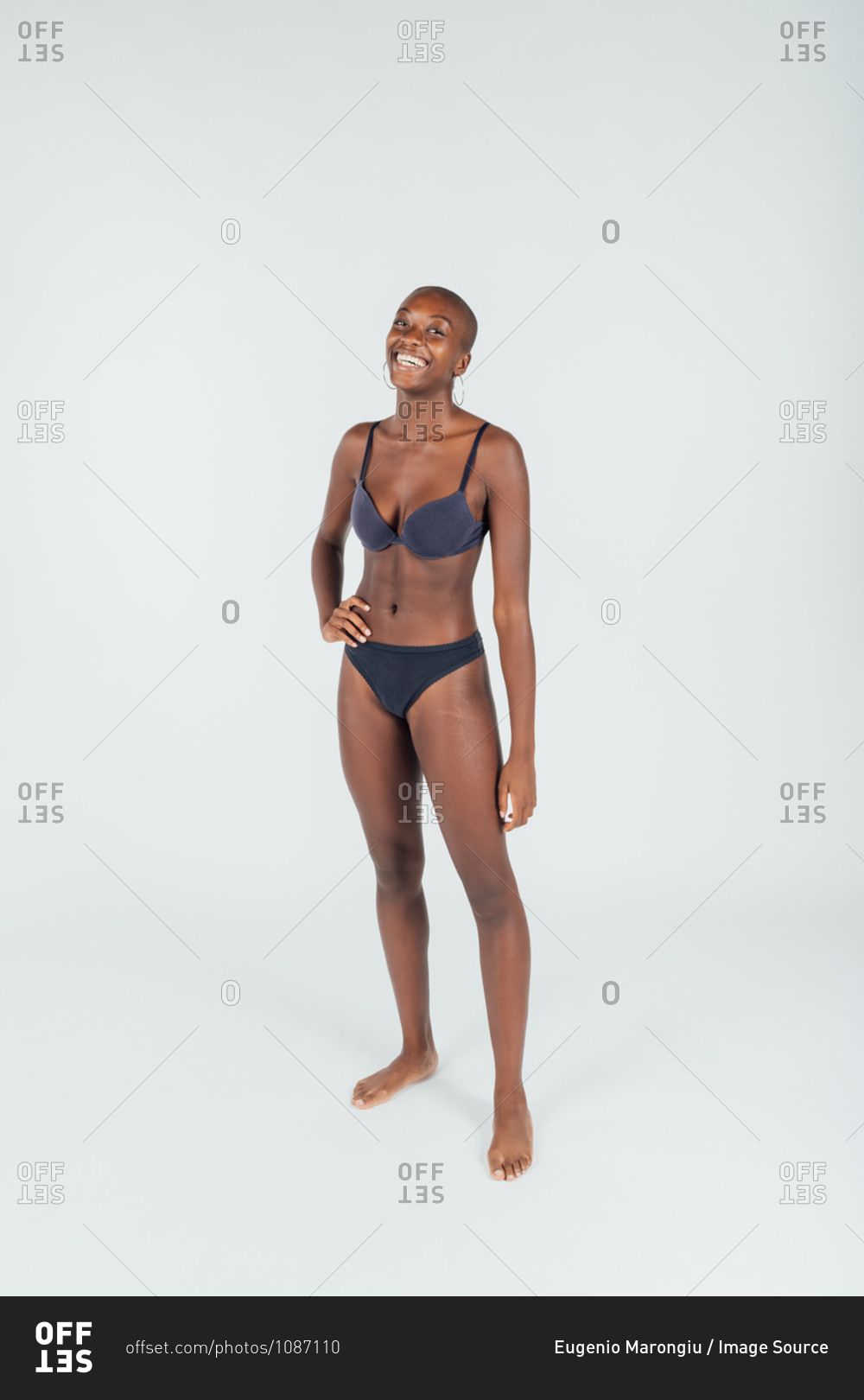 Portrait of a young woman wearing underwear, full length stock photo -  OFFSET