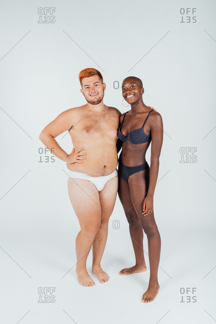 Portrait of young couple in underwear, full length
