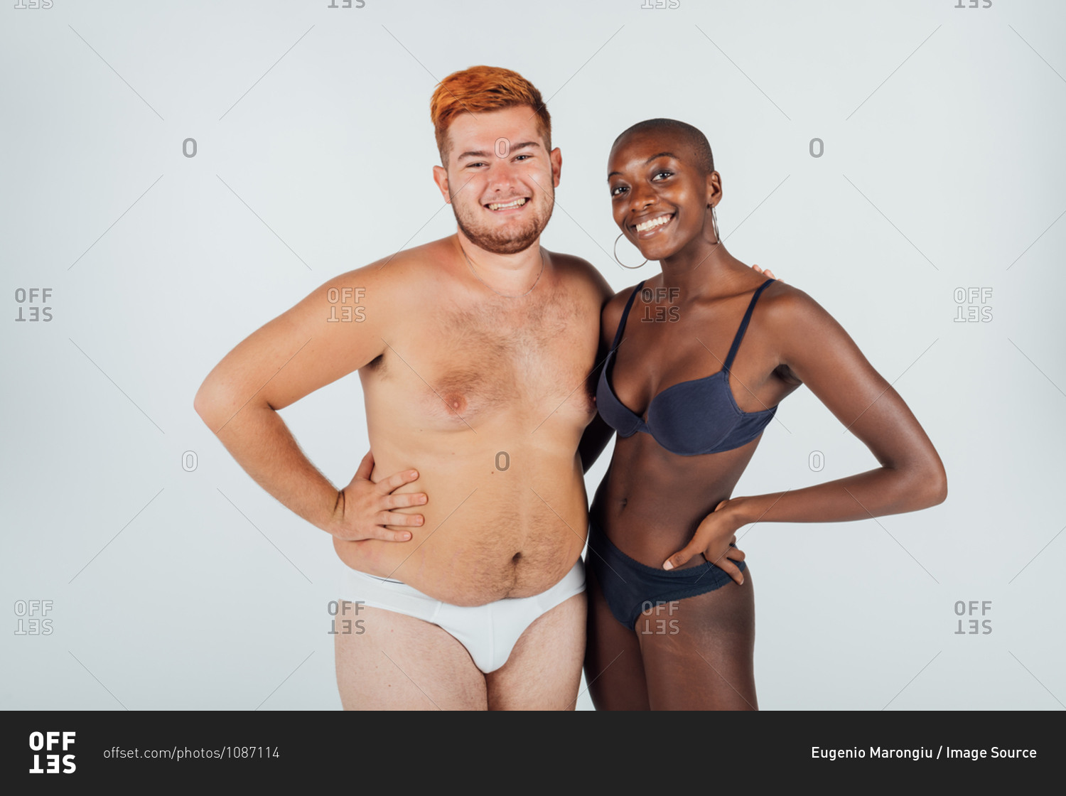 Confident young couple, wearing underwear stock photo - OFFSET
