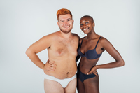 Happy young couple wearing underwear, full length stock photo
