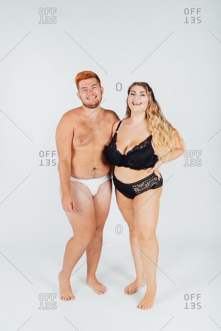 Happy young couple wearing underwear, full length