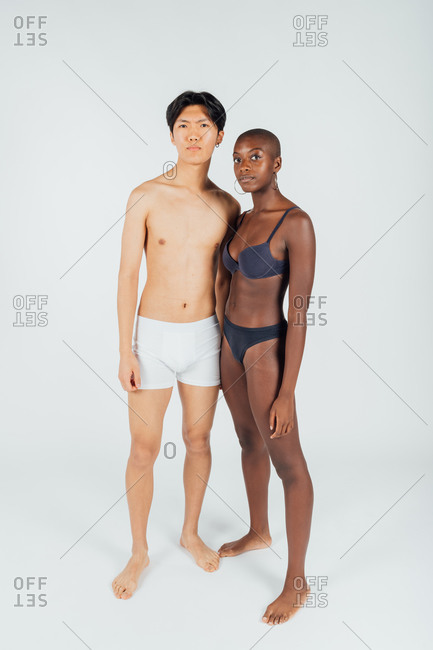 Young couple wearing underwear, full length