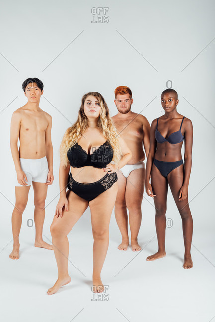 Four young men and women wearing underwear stock photo - OFFSET