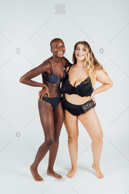 Two confident young women wearing underwear stock photo - OFFSET