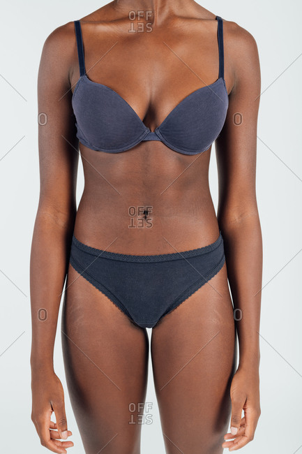 Young woman in underwear, neck down stock photo - OFFSET