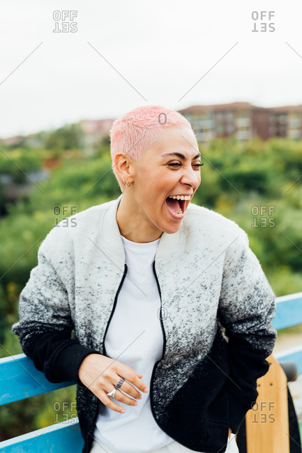 Happy young woman laughing outdoors