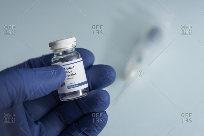 Close-up of hand holding vial with Coronavirus Covid-19 vaccine