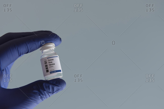 Close-up of hand holding vial with Coronavirus Covid-19 vaccine