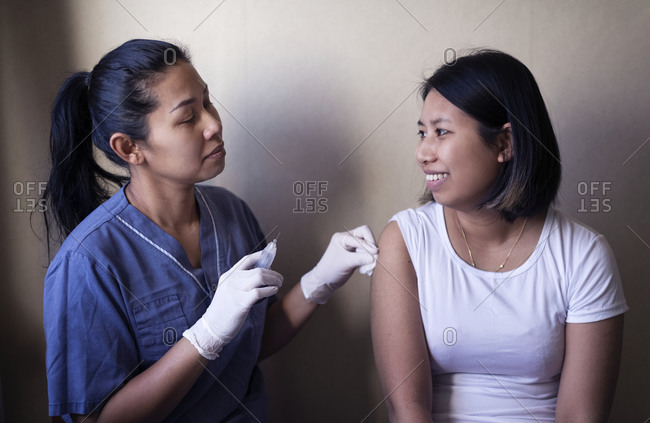 Woman receiving injection in her arm