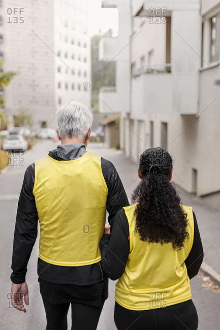 Visually impaired woman walking with guide runner