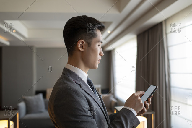 Young businessman looking at his smartphone