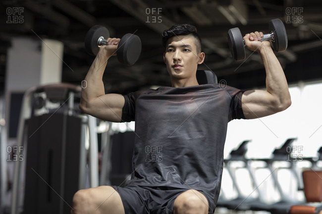 man working out in gym stock photos - OFFSET