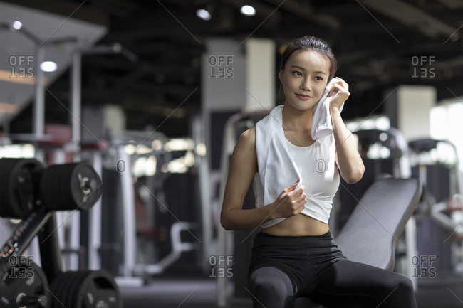 Young Chinese woman working out with personal trainer at gym stock photo -  OFFSET