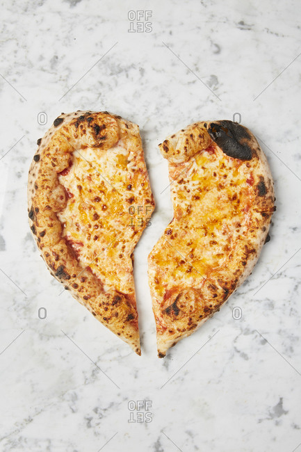 Overhead image of broken heart shaped pizza
