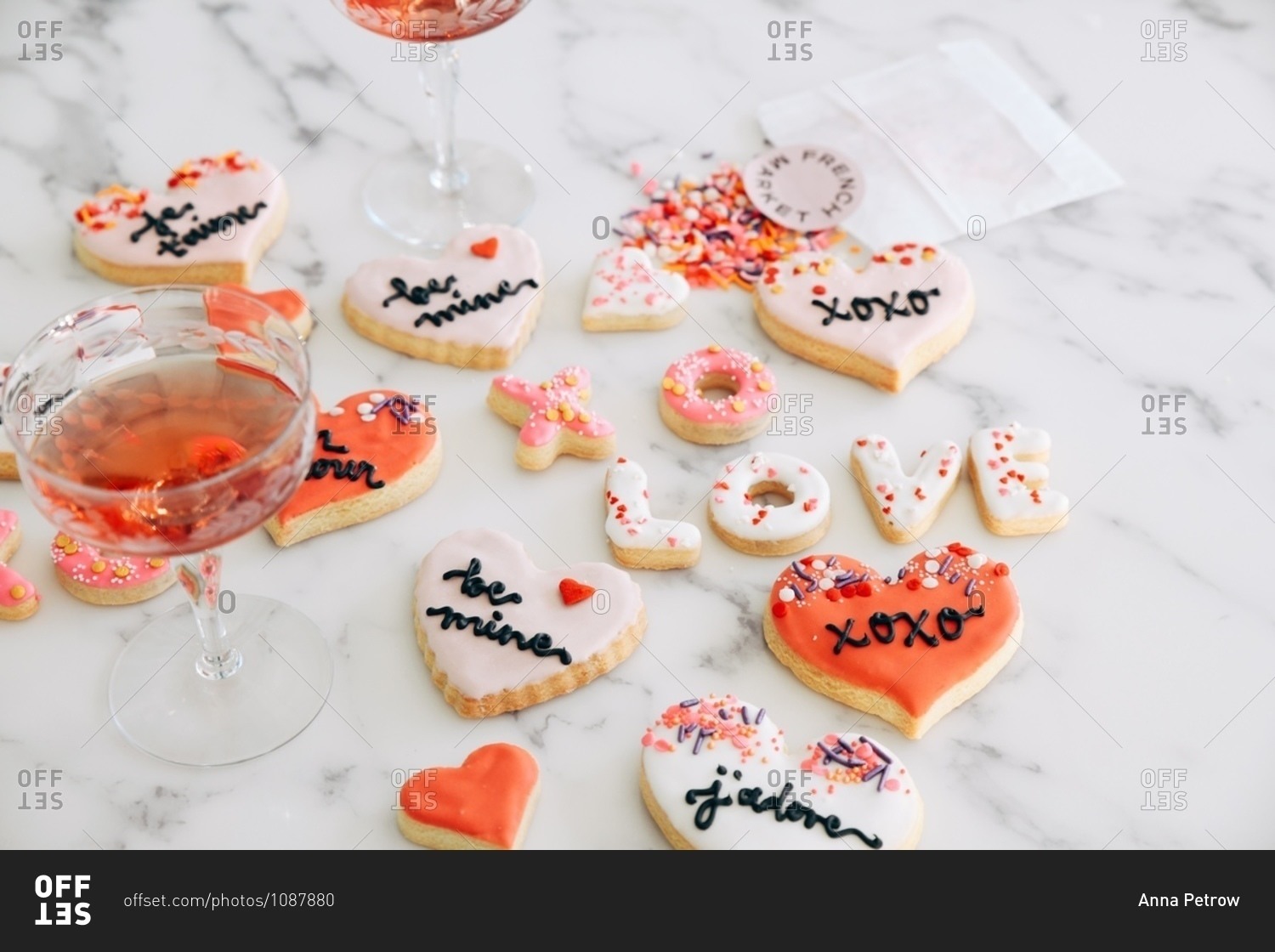 Valentine's Day cookies on white marble surface with blush wine