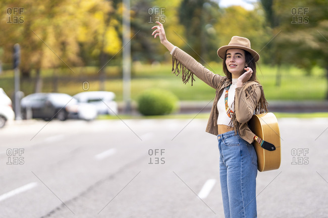 Young musician waving hand on street