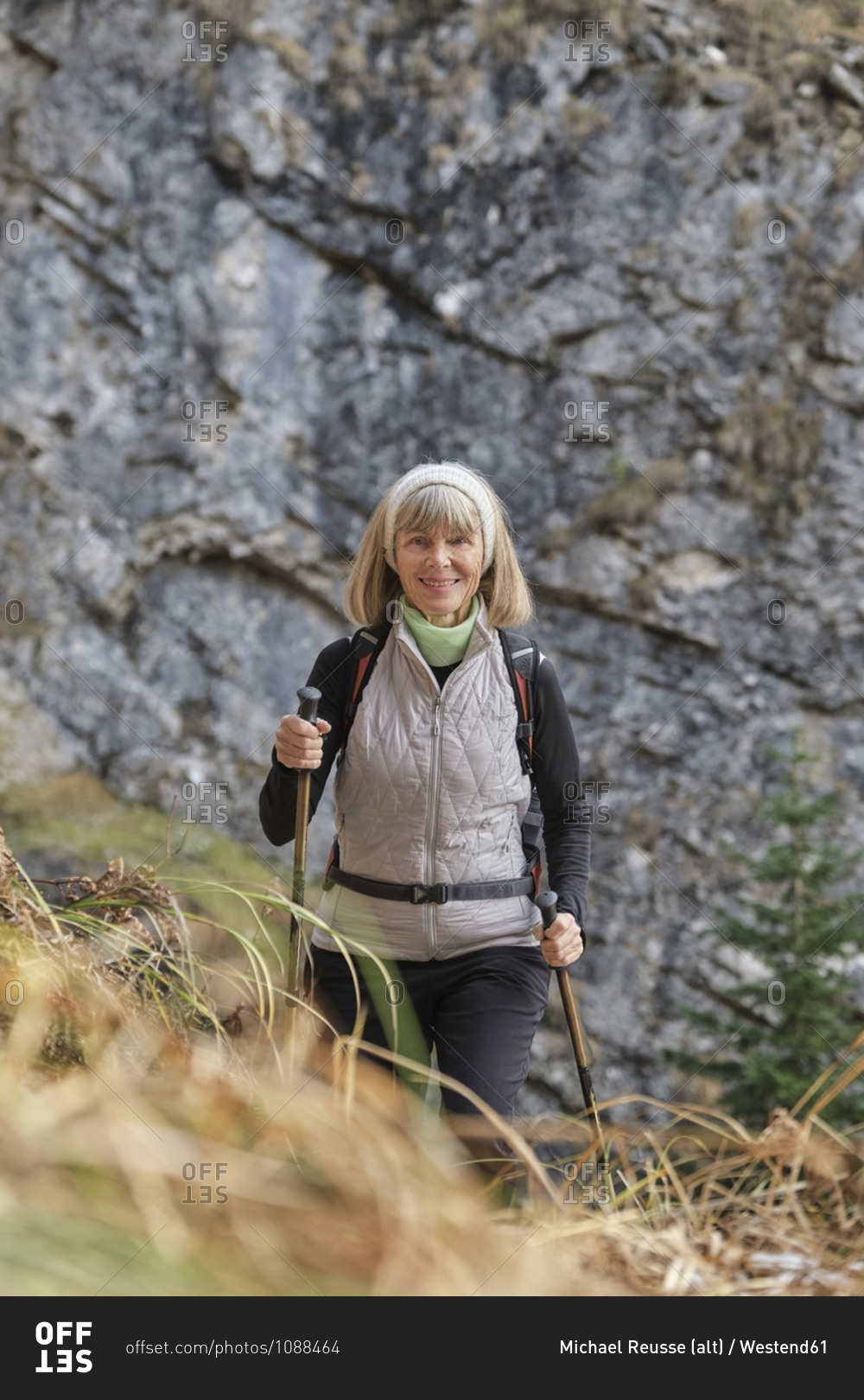 Portrait of senior hiker posing with hiking poles