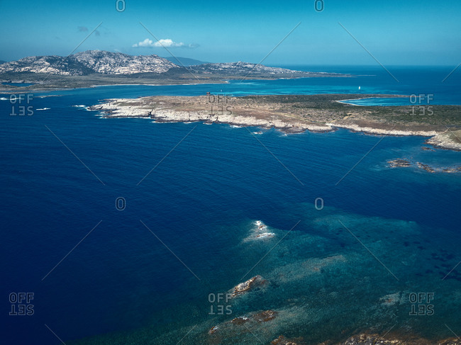 Aerial view of the Asinara island surrounded by crystalline waters near Stintino, Sardinia, Italy.