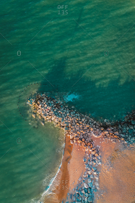 Aerial view of a Groyne, sea defense, at sunset, with shadows, Barton On Sea, New Milton, Hampshire, United Kingdom