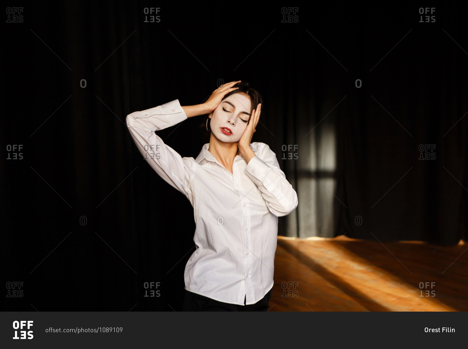 A portrait of an actress woman in a shirt and with done theatrical makeup who is posing like a meme