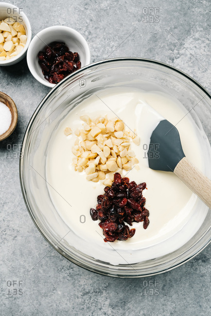 Mixing bowl with white chocolate, cranberries, and macadamia nuts