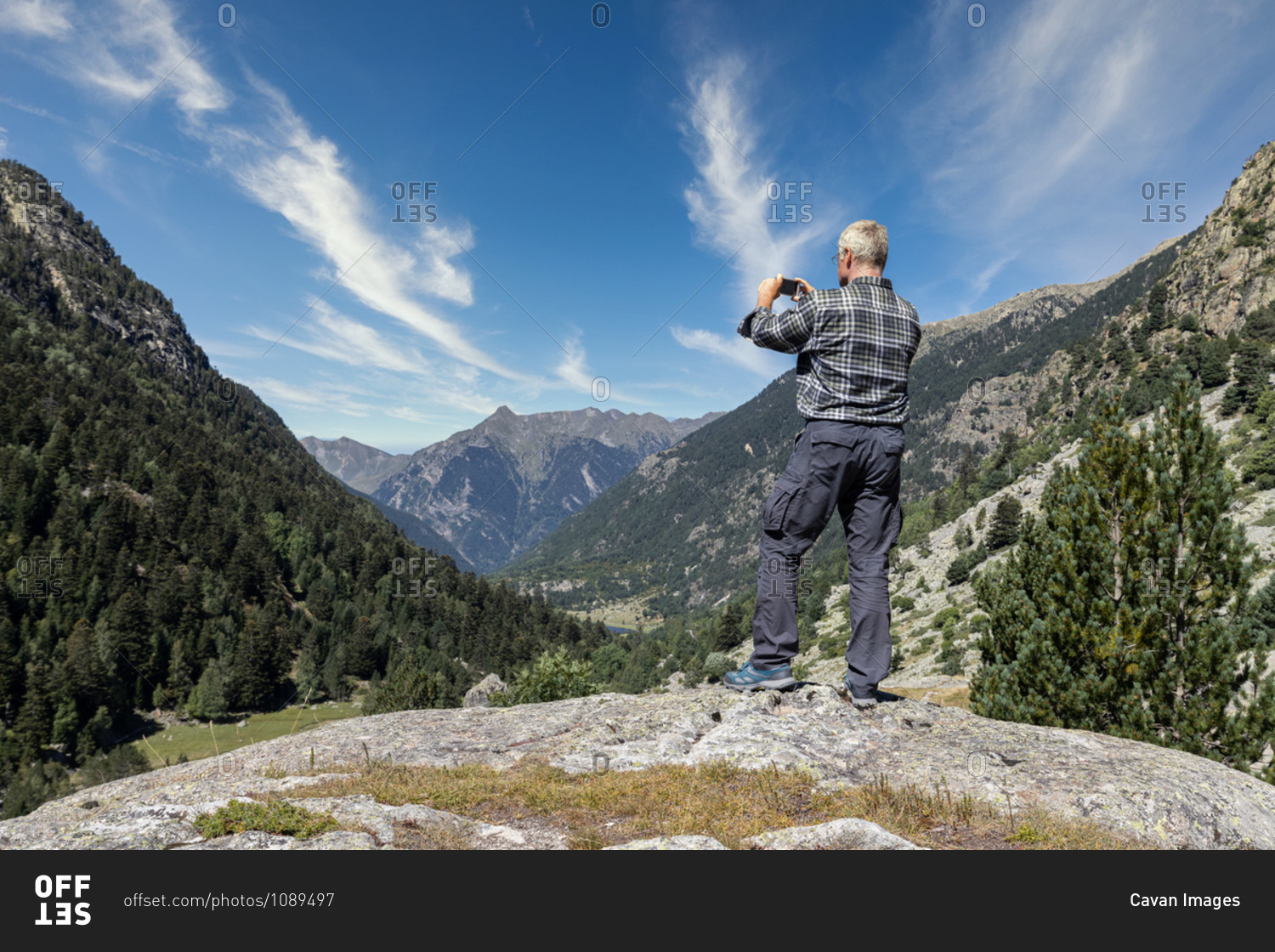 male-middle-aged-tourist-take-pictures-with-mobile-phone-in-spanish