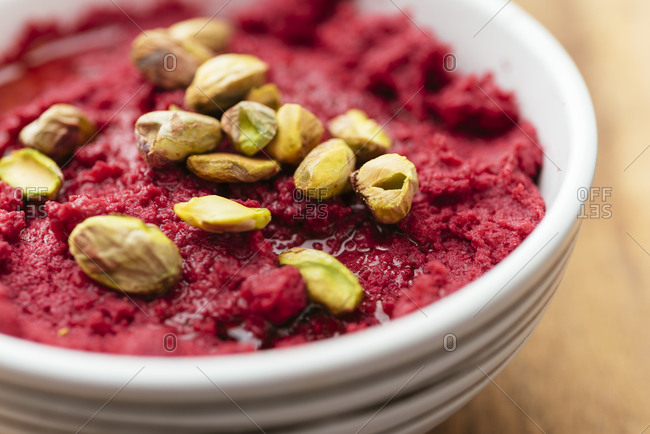 Roasted beetroot hummus garnished with pistachios