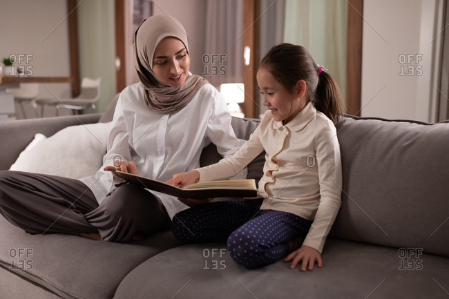 Muslim daughter showing pictures to mother