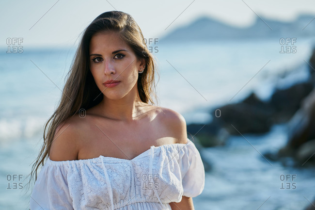 portrait of girl in white dress on the beach in benidorm, spain. Vacation
