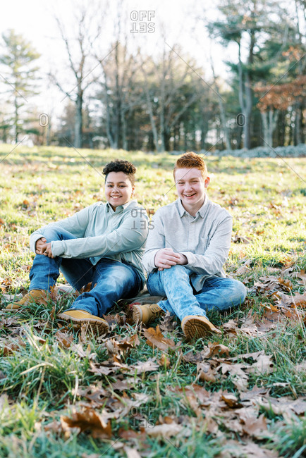 Portrait of mixed race brothers looking into camera in a park