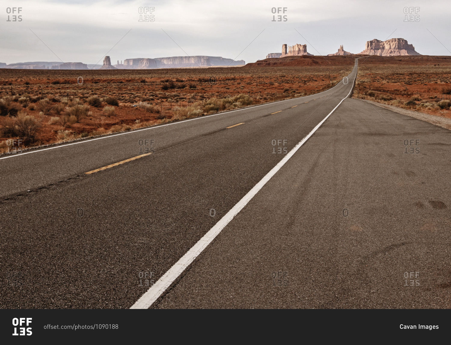 lonely dramatic landscape with road running to Monument Valley, Utah