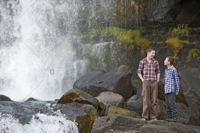 brothers exploring Oxararfoss waterfall at Thingvellir national park