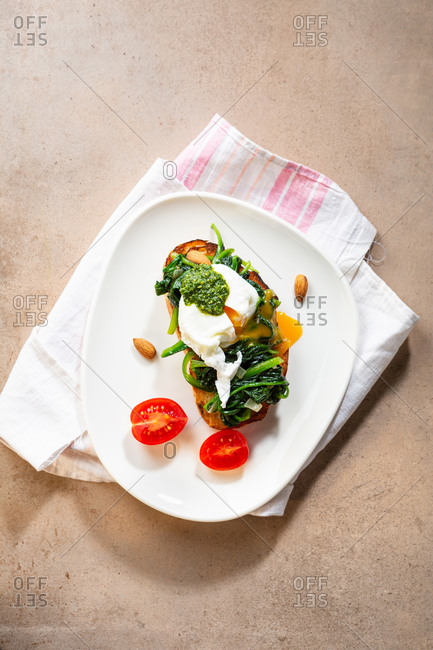 Overhead view of toast with sauteed spinach and poached egg