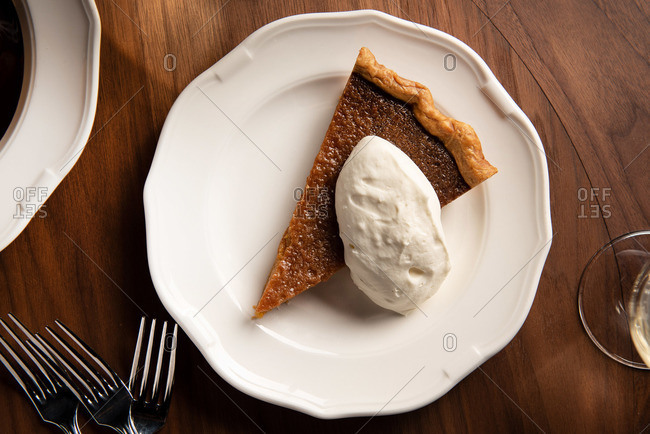 Slice of salted caramel pie with whipped cream