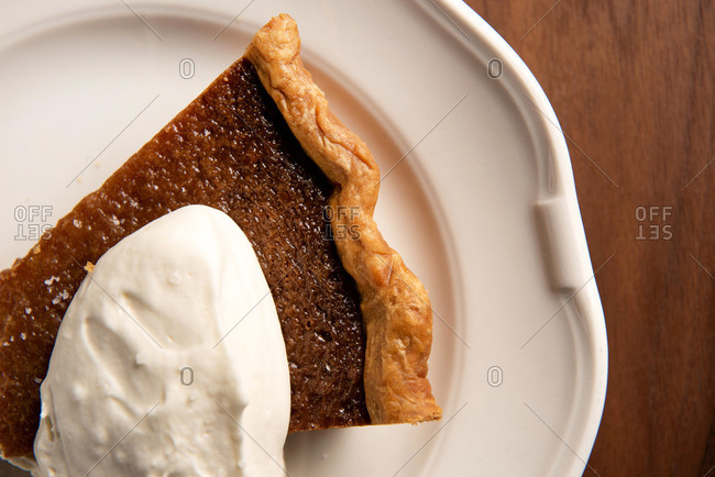 Close up of sliced salted caramel pie with whipped cream