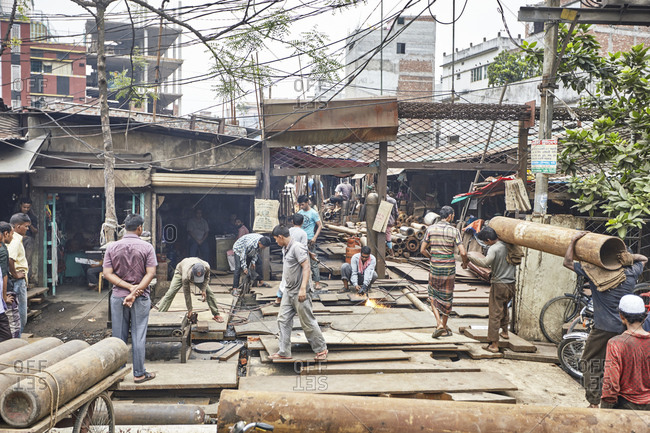 Dhaka, Bangladesh - April 26, 2013: Men working in a metal scrap yard