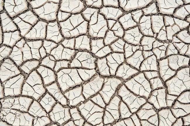 Top view closeup textured background of rough cracked barren waterless soil during drought