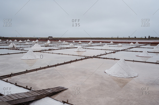 Jingzaijiao Tile paved Salt Fields with dry salt ready for harvesting in cloudy weather in Tainan city in Taiwan