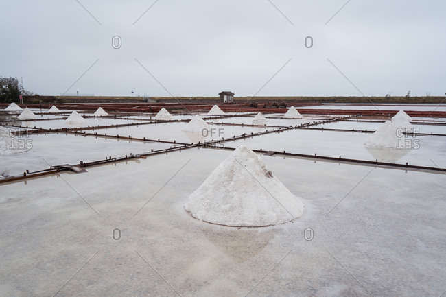 Jingzaijiao Tile paved Salt Fields with dry salt ready for harvesting in cloudy weather in Tainan city in Taiwan