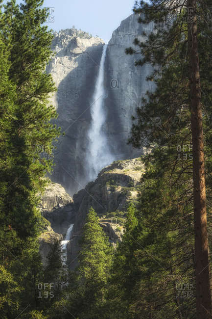 Spectacular scenery of waterfall in rocky mountains in Yosemite National Park on sunny day