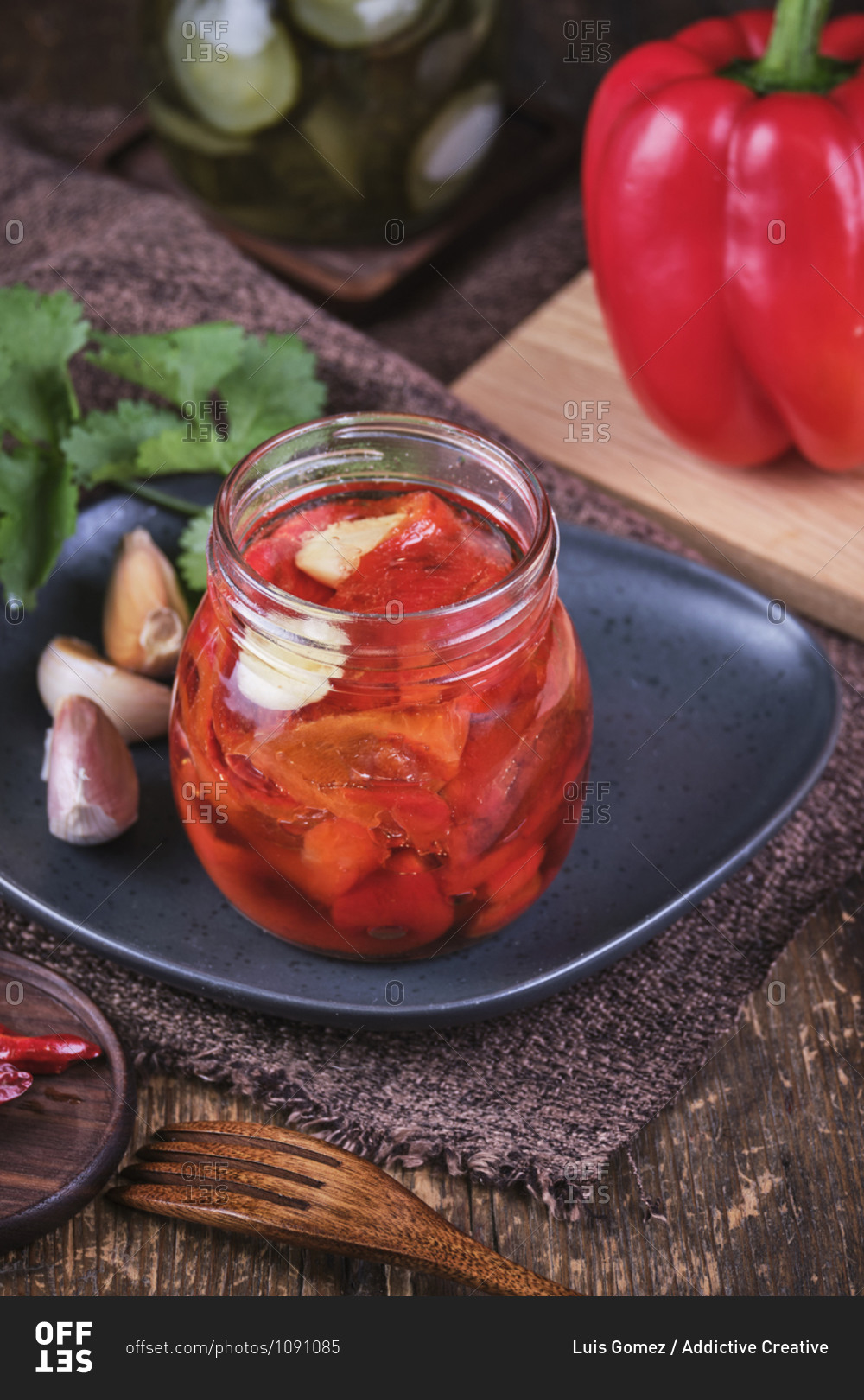 Vegan baked red peppers with garlic in crystal jar.